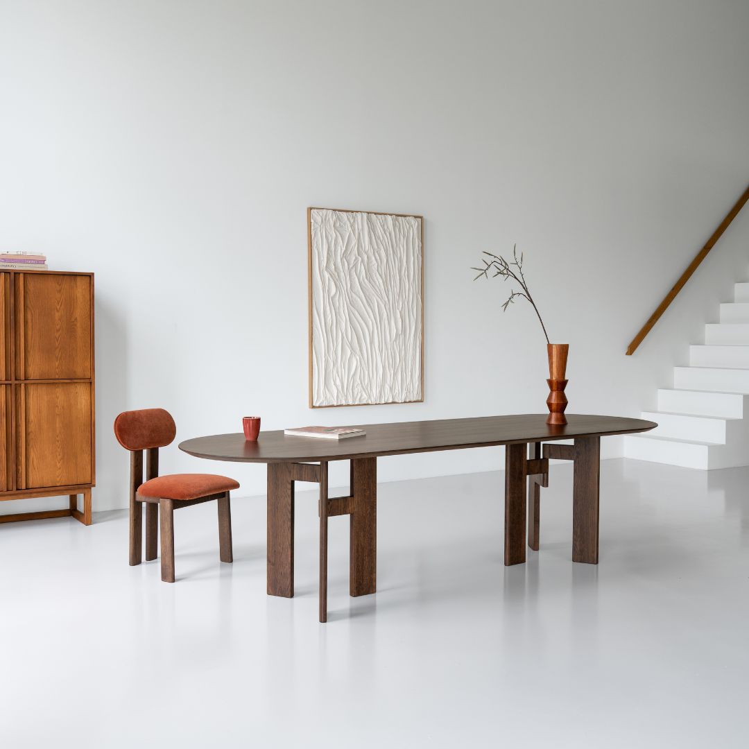 Plat ovale eettafel in notenhout met houten design onderstel